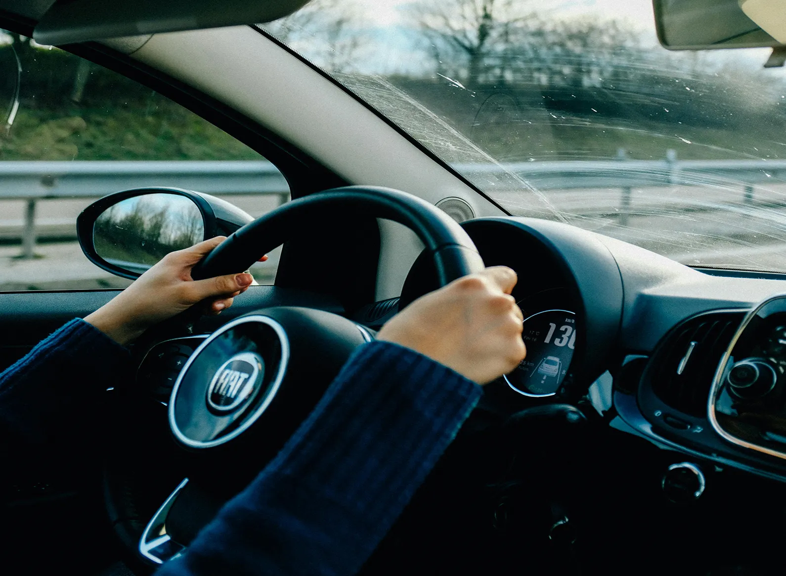 A helper driving a car